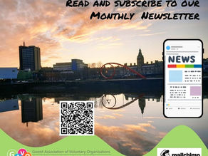 The image shows the mock up of a mobile phone displaying the GAVO news, it is placed in front of the skyline of the riverfront including the "Wave" sculpture, which is a red metal piece of art on the riverfront, behind is the Newport Market building and sunset sky 