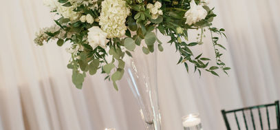 Elegant North Carolina wedding reception table with white floral centerpiece, greenery and navy blue table linens