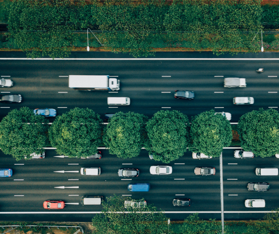 traffic management company, cars and trucks moving on tree-lined highway