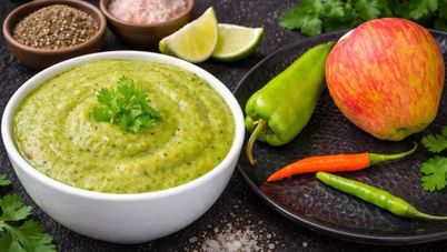 Apple chutney made with fresh apple, green chilli, coriander and spices served in a bowl