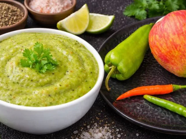 Apple chutney made with fresh apple, green chilli, coriander and spices served in a bowl