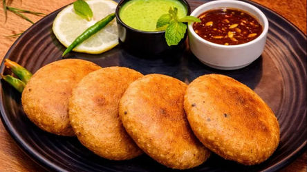 bihari fried sattu litti served with green chutney and tamarind chutney, crispy sattu kachori on plate