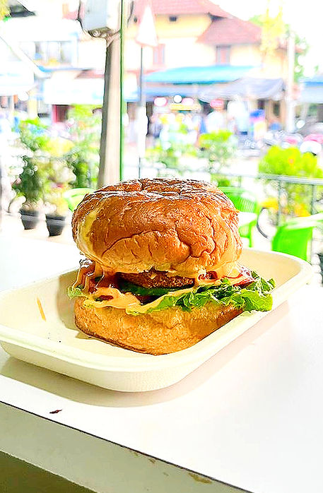 Juicy chicken burger served in a soft bun with fresh lettuce and sauce.