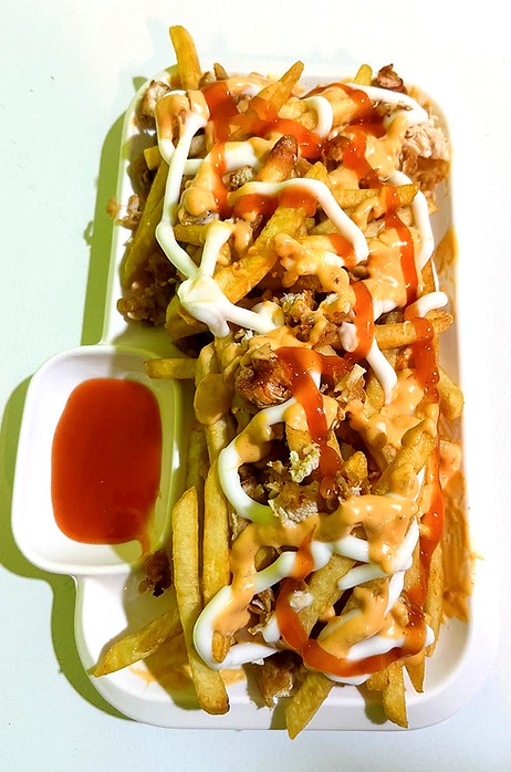 Loaded cheesy French fries with mayo, sauces, and toppings at Momo Popz in Ottapalam.