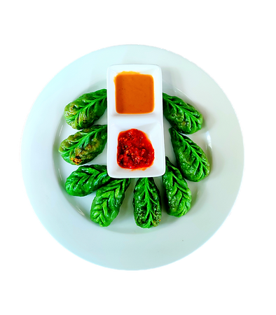 Vibrant green momos with signature sauces, showcasing the creative and modern flavors of Momo Popz in Ottapalam.
