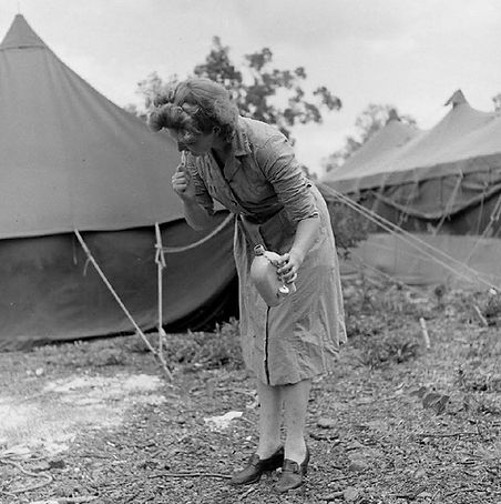 Flight nurse on Guadalcanal brushing her
