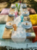 Table for 6 luxury picnic setup with dinnerware pillows and boho decor
