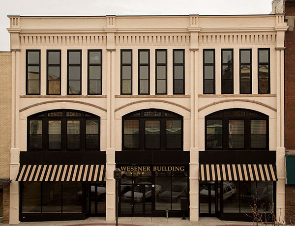 Restored Wesener Building, a historic mixed-use redevelopment with retail and apartments in downtown Owosso, Michigan.
