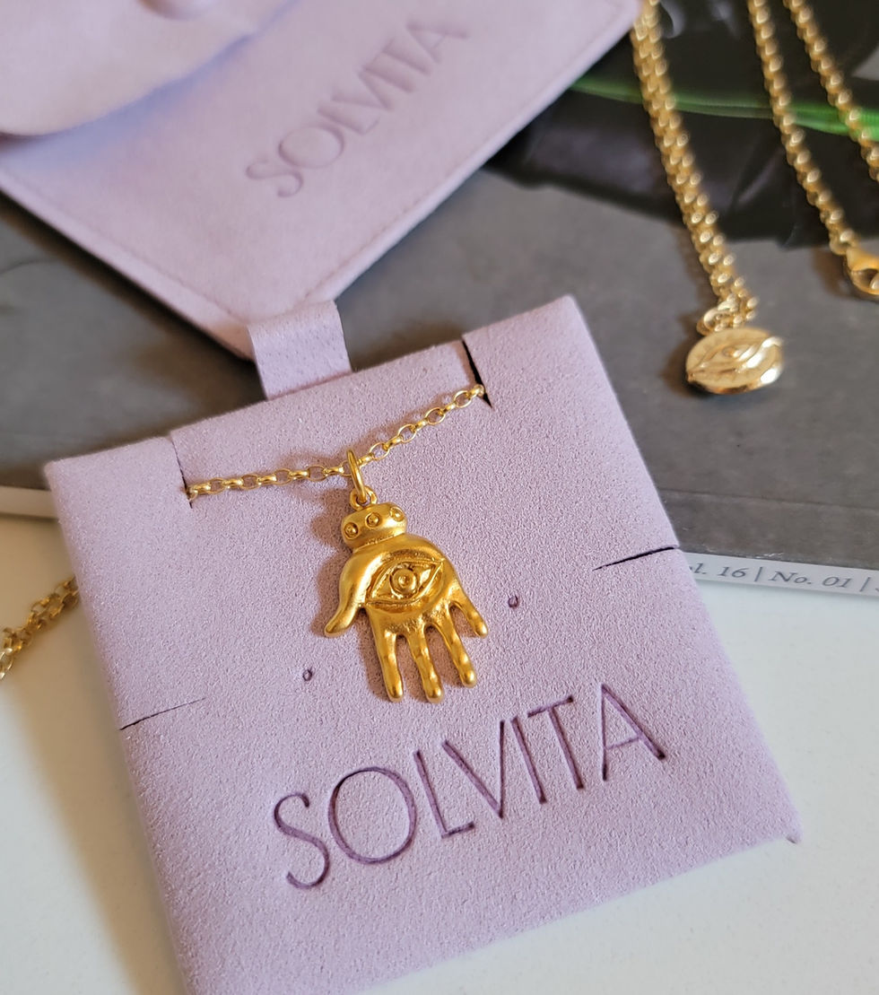 Thumbnail: Hamsa necklace in gold shown with Solvita Collection mauve microsuede packaging.