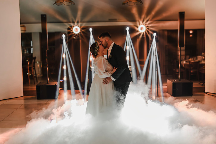 Fotograf ślubny Poznań- Uśmiechnięta para młoda na tle świateł i dymu. Oferta ślubna.