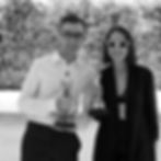 Man and woman holding Oscar awards