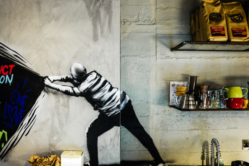 Interior detail of cafe with graffiti art. Black Sheep Coffee interior design.