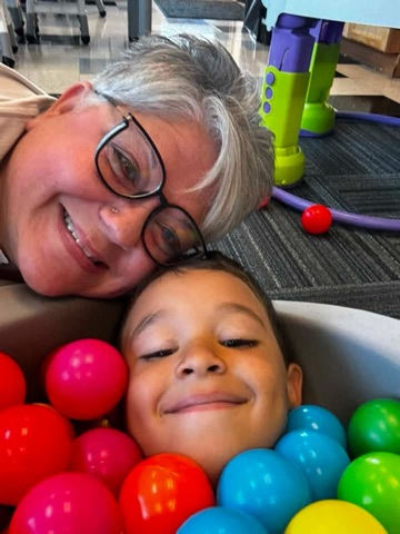 Teacher Bobbi taking a picture with one of her students