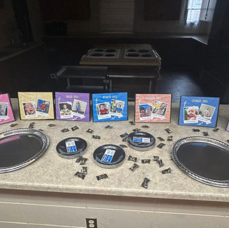 Plates for cookies and signs with pictures of the kids graduating