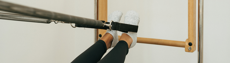 Beginner feet in straps on Pilates cadillac