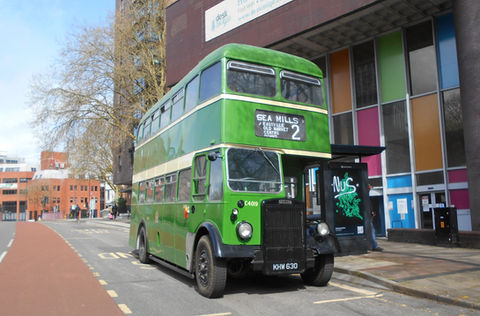 A shiny green double deck bus
