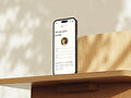 mockuuups-free-iphone-mockup-on-a-wooden-desk-in-sunlight.jpeg