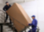 Professional workers carrying refrigerator on stairs indoors.jpg