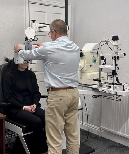 Optometrist performing an advanced eye examination using diagnostic equipment at Parkhurst and Co independent opticians in Doncaster.