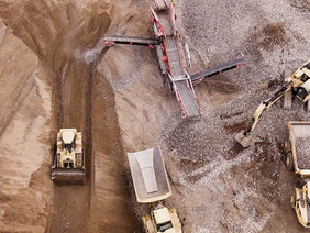 Mining site in Zimbabwe with heavy machinery and stockpiles