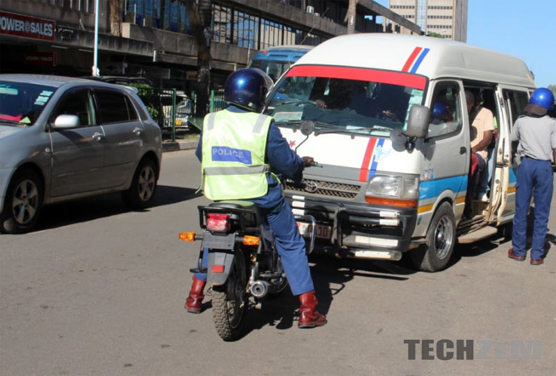 Traffic police officer manually directing vehicles at a functioning intersection in Harare, Zimbabwe