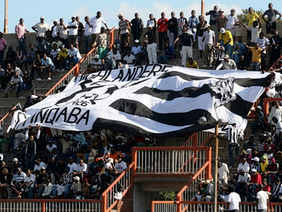 Highlanders FC supporters crowd in black and white