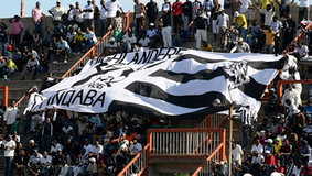 Highlanders FC supporters crowd in black and white