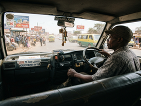 Interior perspective of a Zimbabwean kombi commuting during the morning rush hour.