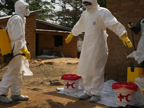 Medical staff disinfecting an Ebola treatment centre in Uganda