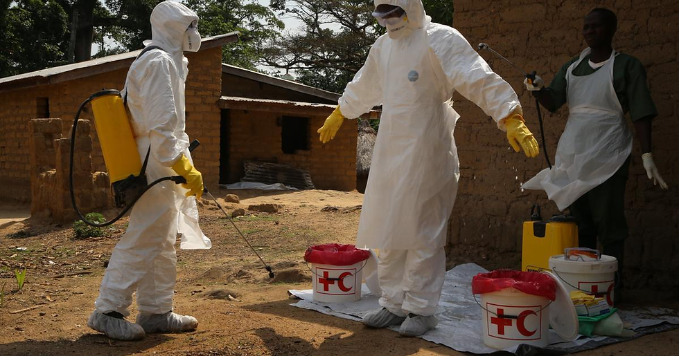 Medical staff disinfecting an Ebola treatment centre in Uganda