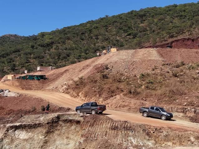 Mining equipment operating on a hillside near residential areas in Mutare.