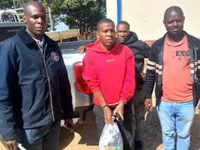 Former N Richards cashier Tawanda Manzinde appearing in court after extradition from Zambia.