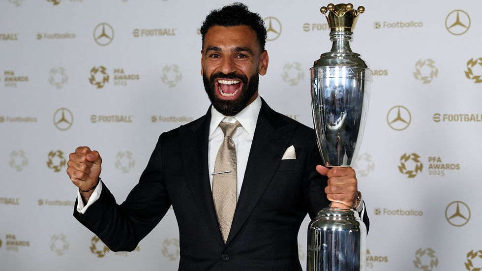 Man in suit celebrating with large trophy against a backdrop of "PFA Awards 2023" logos. He's smiling joyfully, exuding excitement.
