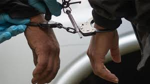 hands in handcuffs seized during crime investigation