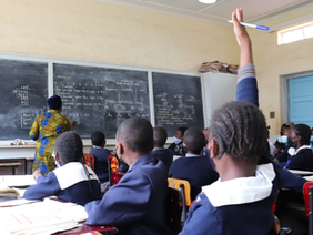 Students and teachers in Zimbabwe private school setting