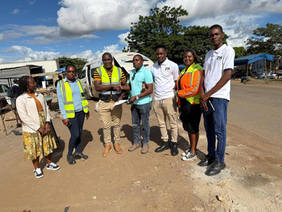Road construction site handover — contractor and ministry officials at the site handover