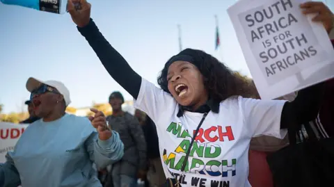 Anti-immigration protest in South Africa as business leaders call for lawful solutions to rising tensions over undocumented migration.