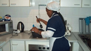 Domestic worker performing household duties in Zimbabwe.