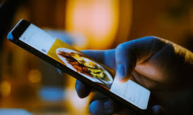 Person scrolling through social media feeds on a smartphone.