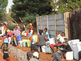 Harare residents queue at a community borehole during prolonged water shortages