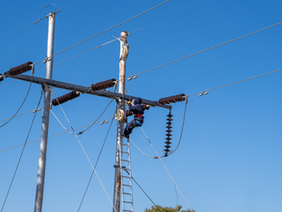 Damaged low‑hanging power line over a rural road — low‑hanging cables hazard