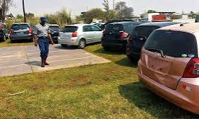 Zimbabwe Republic Police officers conducting a roadside vehicle inspection.