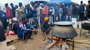 Displaced Malawian migrants gathered in a field in Sherwood, Durban.
