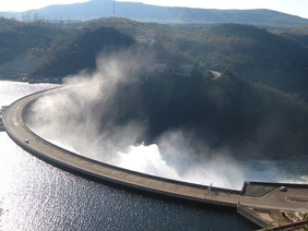 A wide-angle shot of the Kariba Dam wall showing the low water marks and the hydroelectric intake towers.