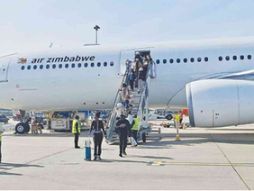 Passengers boarding an Air Zimbabwe international flight.