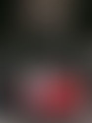 In the luminous flash-kissed light of Lake Garda, a woman in a flowing white coat and elegant sunglasses stands poised on a seaside terrace, her hair gently windblown by the Mediterranean breeze. Behind her, the vivid azure waters merge seamlessly with the clear sky, creating a timeless cinematic backdrop of pure Italian elegance. Captured during the Dolce Vita-inspired editorial photoshoot with AC Fotografia, this refined moment blends effortless style, authentic presence, and classic La Dolce Vita charm. With the iconic vintage red Fiat 500 waiting nearby, every detail — from the natural wind-swept movement to the precise balance of ambient light and flash — contributes to a sophisticated visual story of freedom, romance, and enduring Italian heritage.