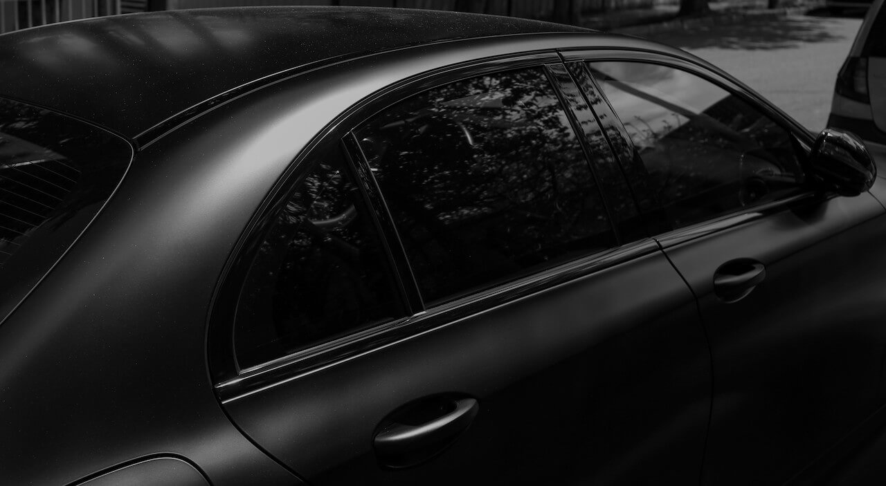 Dark vehicle with tinted side windows