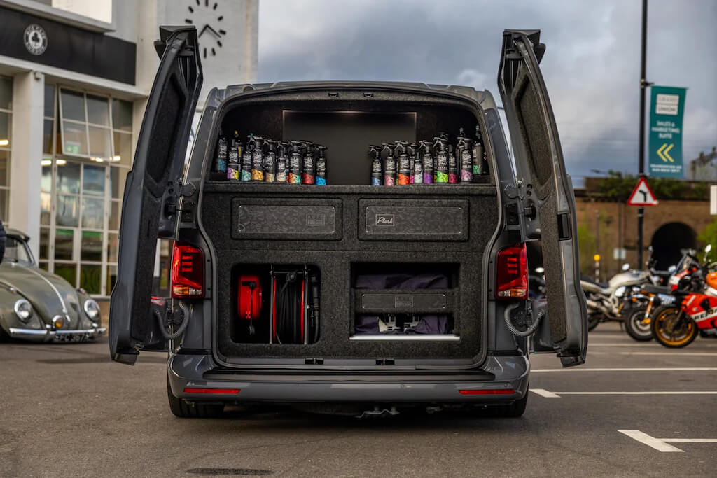 Open mobile detailing van with equipment and supplies