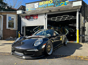 Black Porsche 911 freshly detailed outside the 5Boro Auto Detailing shop in Flushing, Queens NY