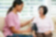 Nurse taking womans blood pressure